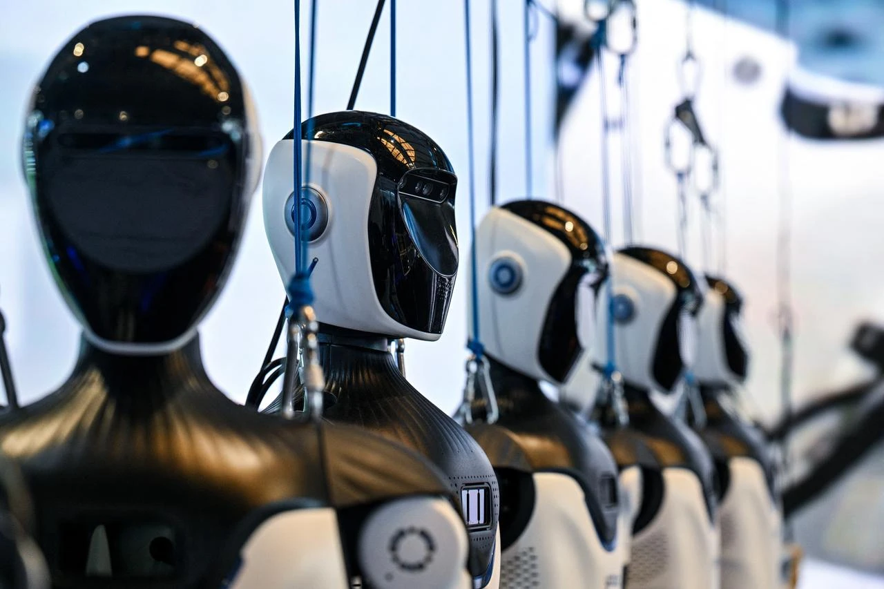 Humanoid robots by OpenMind Robotics are seen during the World Artificial Intelligence Conference (WAIC) in Shanghai, China, July 18, 2026. (AFP Photo)