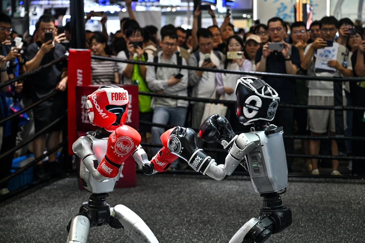 Humanoid robots controlled by a remote control by Unitree Robotics take part in a fight during the World Artificial Intelligence Conference (WAIC) in Shanghai, China, July 18, 2026. (AFP Photo)