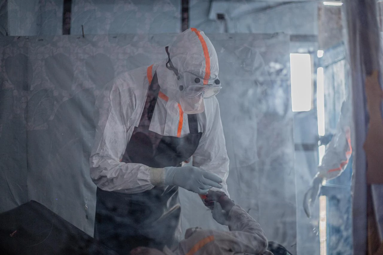 Health workers wearing protective equipment assist a patient inside an Ebola treatment unit in the Democratic Republic of Congo, July 14, 2026. (AFP Photo)