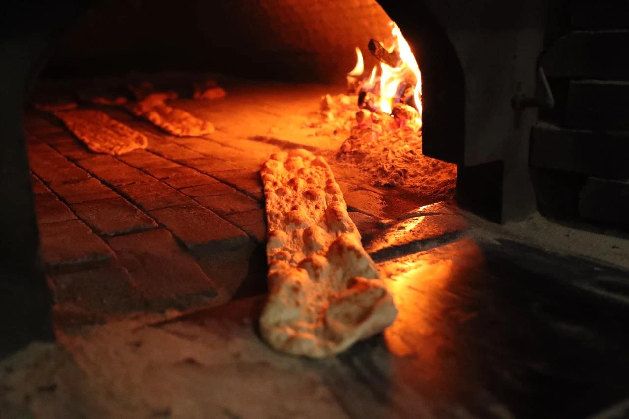 Traditional Egin bread bakes in a wood-fired oven in Kemaliye, Erzincan, Türkiye, July 22, 2026. (AA Photo)
