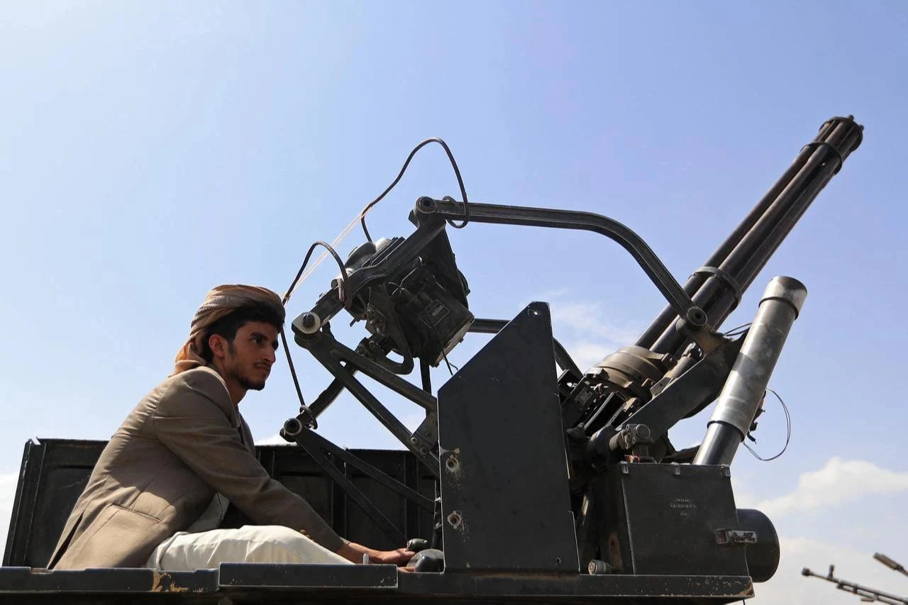 A Yemeni gunman brandishes his weapon during a rally to recruit more in Sanaa on July 6, 2026. (AFP Photo)