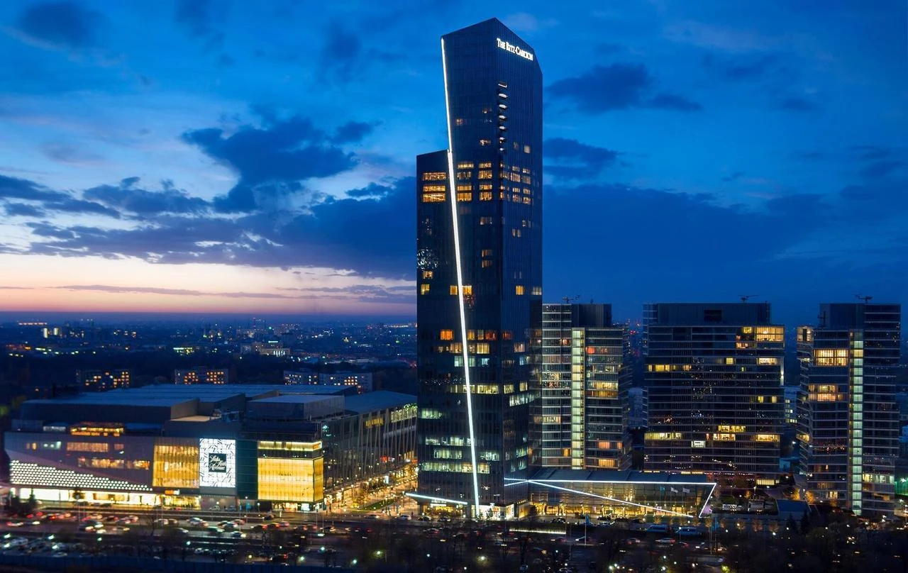 The illuminated Esentai Tower—home to The Ritz-Carlton, Almaty—stands alongside Esentai Mall, where global luxury brands like Saks Fifth Avenue, Louis Vuitton, and Prada line the district hosting VISA Fashion Week.The illuminated Esentai Tower—home to The Ritz-Carlton, Almaty—stands alongside Esentai Mall, where global luxury brands like Saks Fifth Avenue, Louis Vuitton, and Prada line the district hosting VISA Fashion Week.