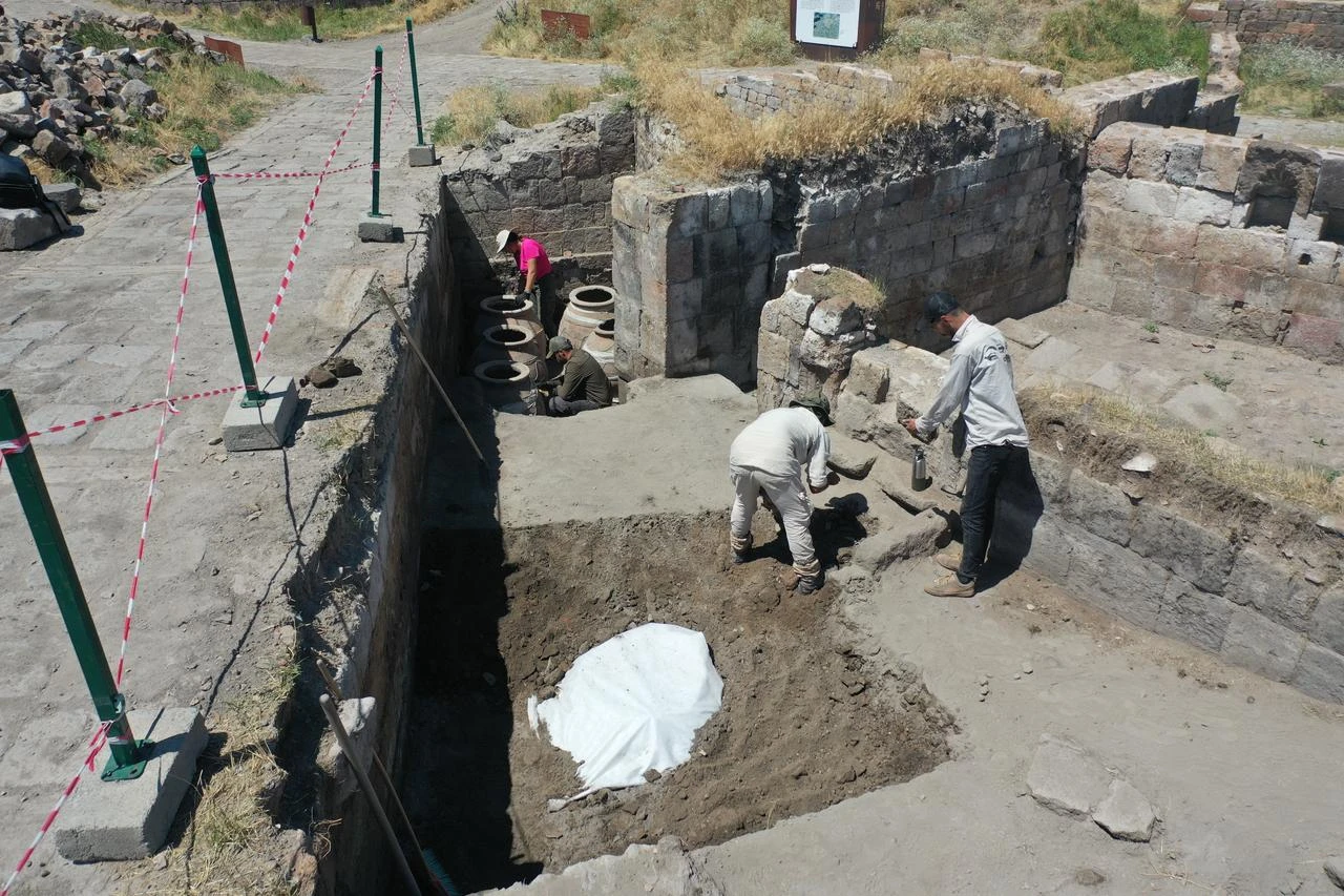 Archaeologists work at the newly uncovered food storage room in the Seljuk marketplace at the Ani archaeological site in Kars, eastern Türkiye, July 23, 2026. (AA Photo)