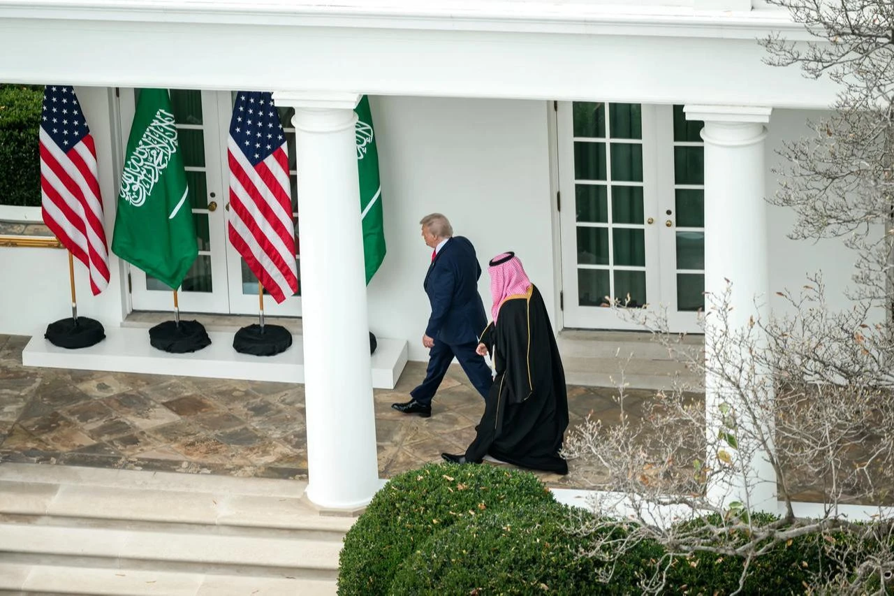President Donald Trump and Saudi Arabia's Crown Prince Mohammed bin Salman walk along the West Wing Colonnade during a high-level diplomatic meeting at the White House on November 18, 2025.