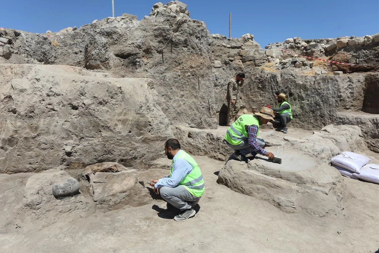 Archaeologists clean and document remains inside a newly uncovered ancient temple area in Elazig, Türkiye, July 23, 2026. (AA Photo)
