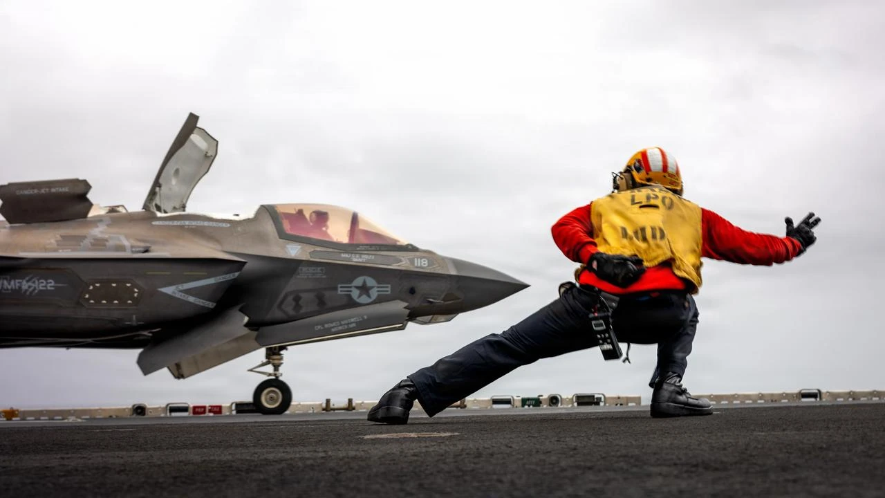 A U.S. sailor signals a U.S. Marine Corps F-35B Lightning II to take off during flight operations aboard the U.S. Central Command area of responsibility, July 17, 2026. (Photo via U.S. Marine Corps)