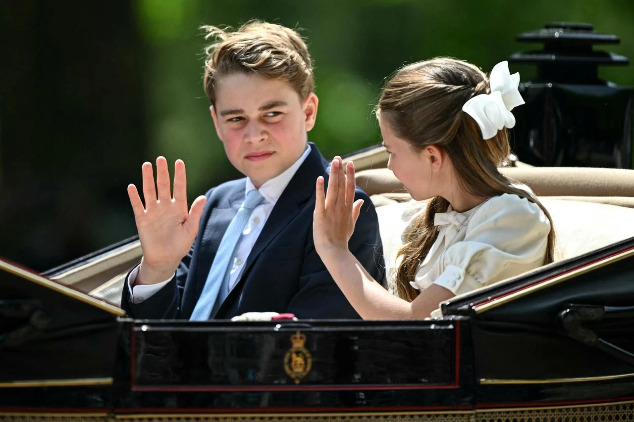Britain's Prince George of Wales (L) and Britain's Princess Charlotte of Wales wave as they make their way back to Buckingham Palace on June 13, 2026. (AFP Photo)