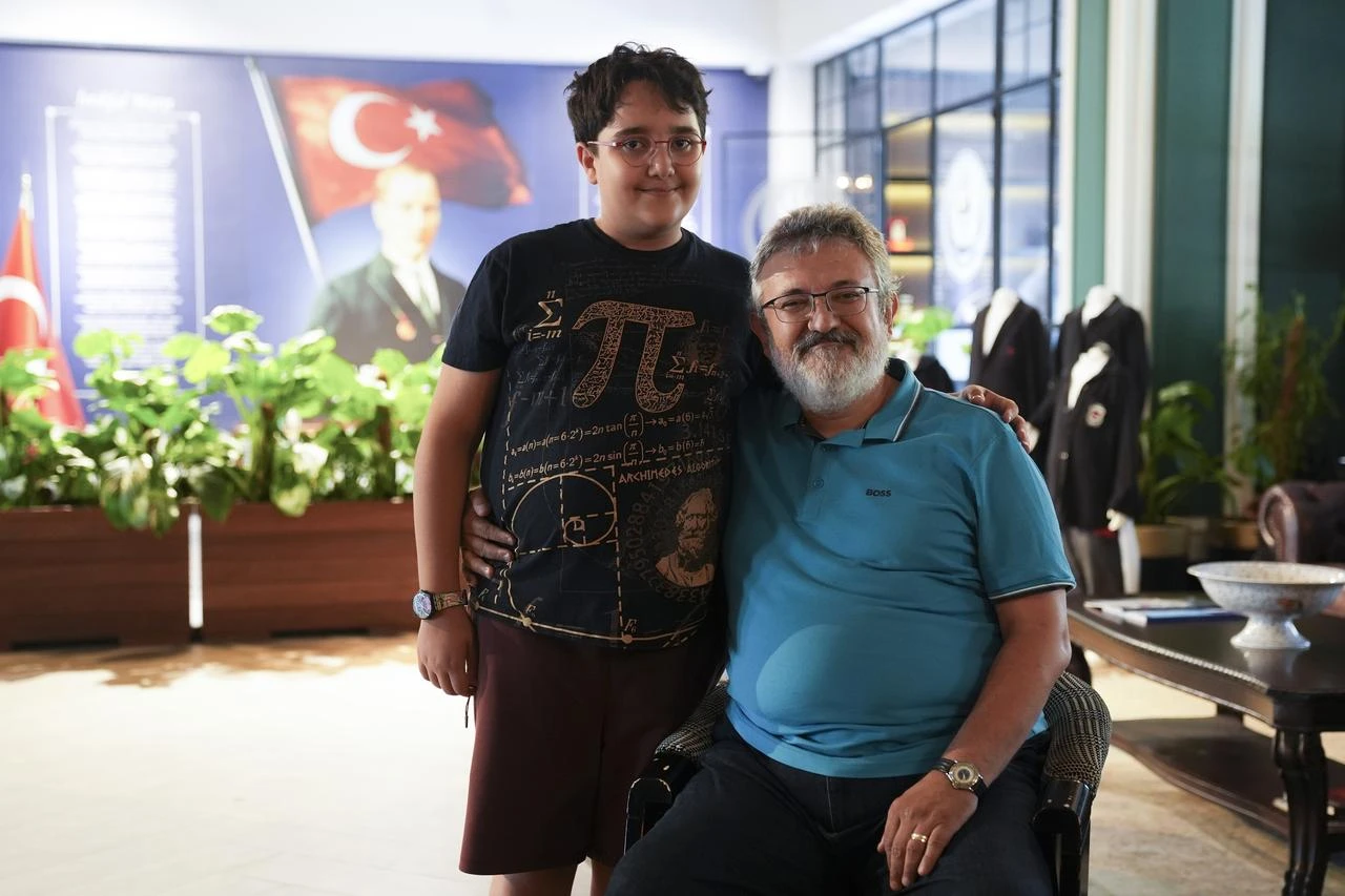 A Turkish student poses with an accompanying adult after achieving international success at the World Mathematics Invitational finals in Japan, Türkiye, July 22, 2026. (AA Photo)
