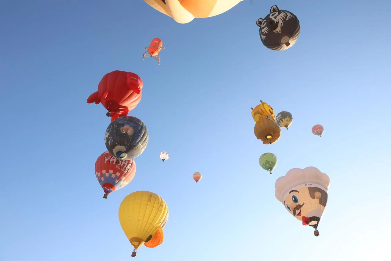 Figurine-adorned hot-air balloons soar over Cappadocia’s fairy chimneys during the seventh “Cappadocia Balloon Festival” in Nevsehir. (AA Photo)