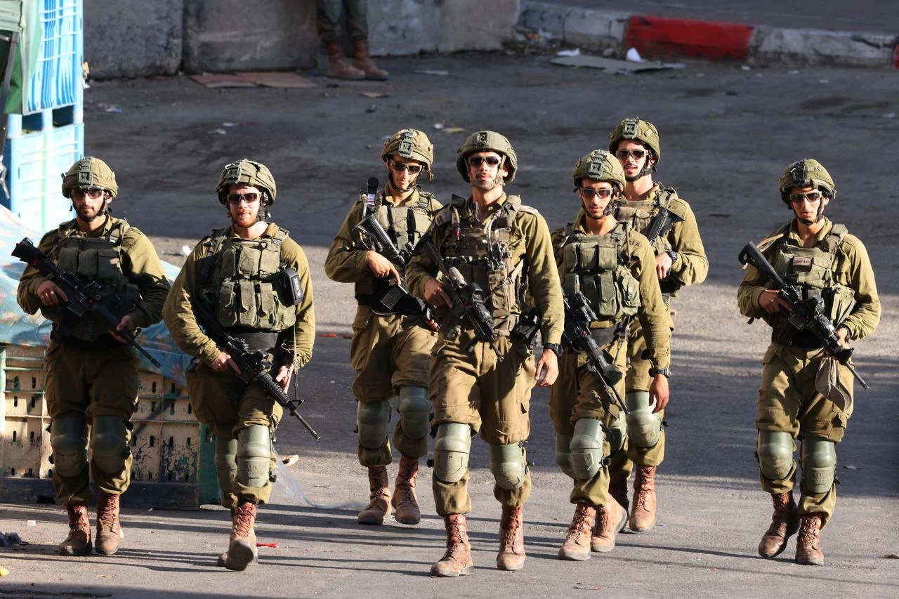 Members of Israeli security forces patrol along a street after barricading the Palestinian side of the city center in the occupied West Bank, July 23, 2026. (AFP Photo)