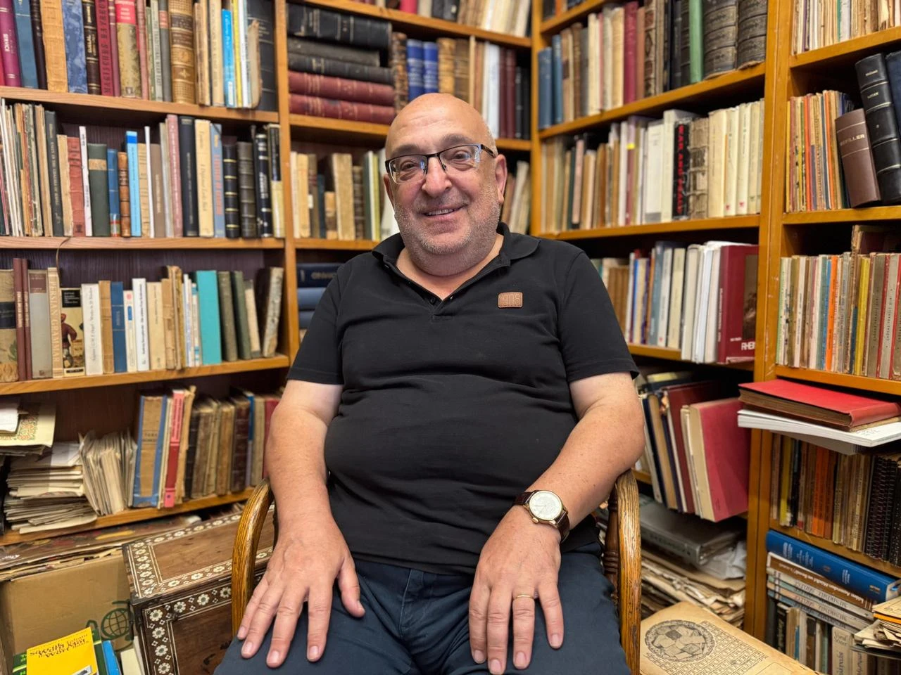 Turkish antiquarian bookseller Nedret Isli sits among rare and secondhand books at Turkuaz Sahaf in Istanbul, Türkiye. (AA Photo)