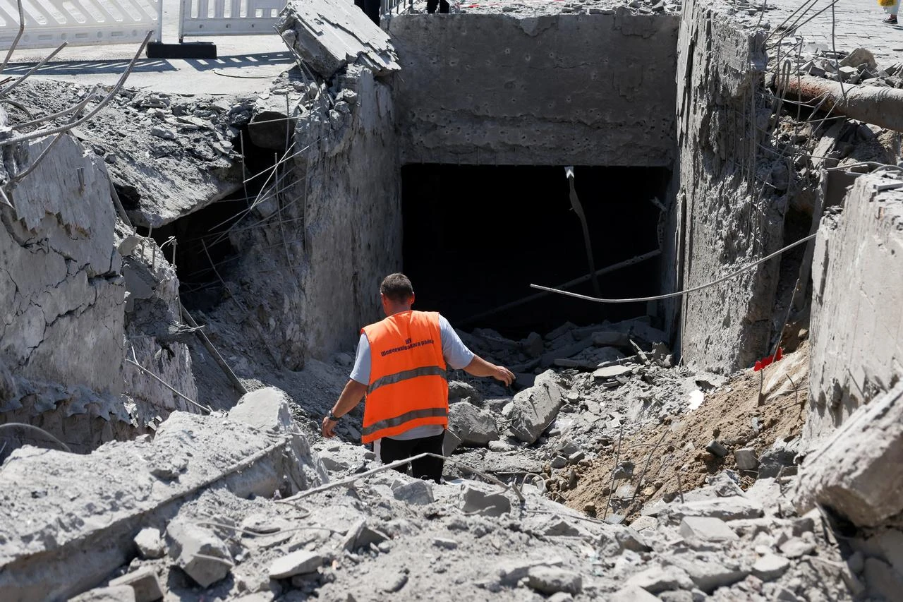 Communal workers clear debris from an underground pedestrian crossing damaged by missile strikes in Kyiv on July 19, 2026, amid the Russian invasion of Ukraine. (AFP Photo)