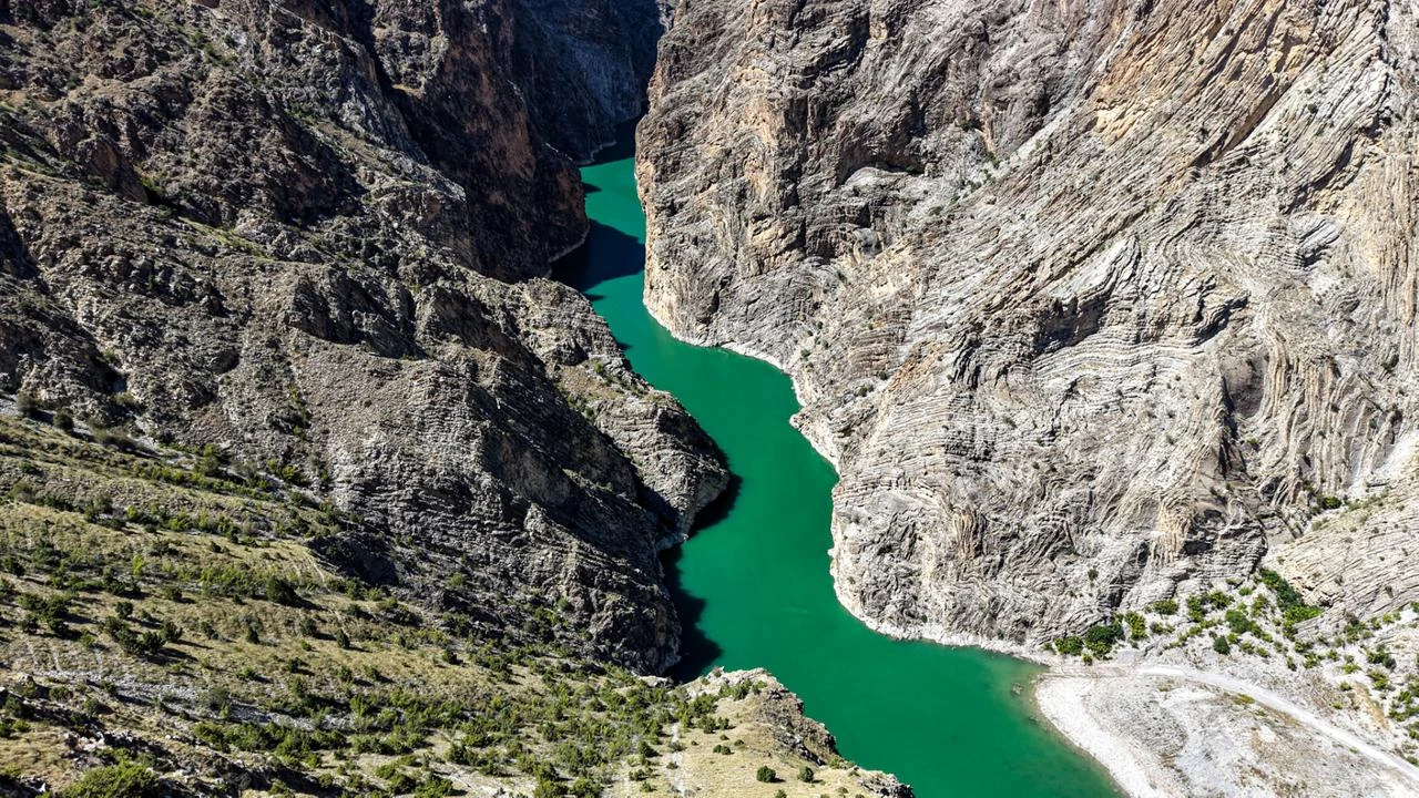 Canoeists paddle through a canyon born from Yusufeli Dam