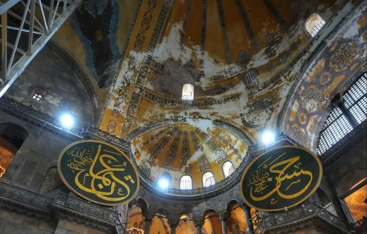 A view of Hagia Sophia’s historic interior shows its decorated surfaces and monumental calligraphic medallions as restoration work continues on the main dome. (AA Photo)