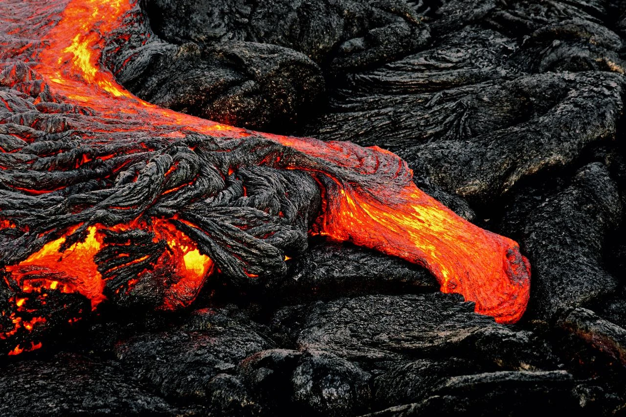 Hot magma escapes from an earth column as part of an active lava flow in Hawaii, Big Island, volcano "Kilauea.'' (Photo via Adobe Stock)