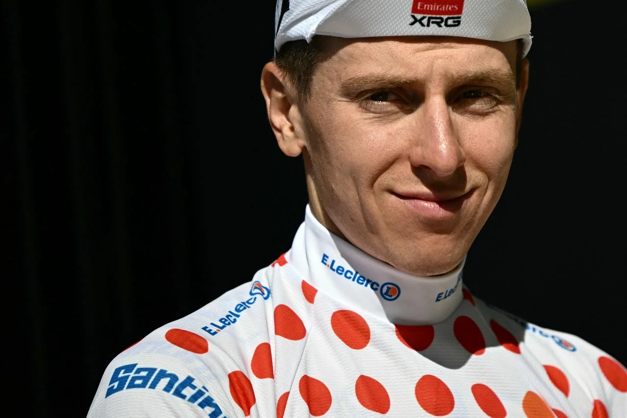 Slovenian rider Tadej Pogacar celebrates on the podium with the best climber's polka dot (dotted) jersey after the 18th stage of the 113th edition of the Tour de France cycling race. (AFP Photo)