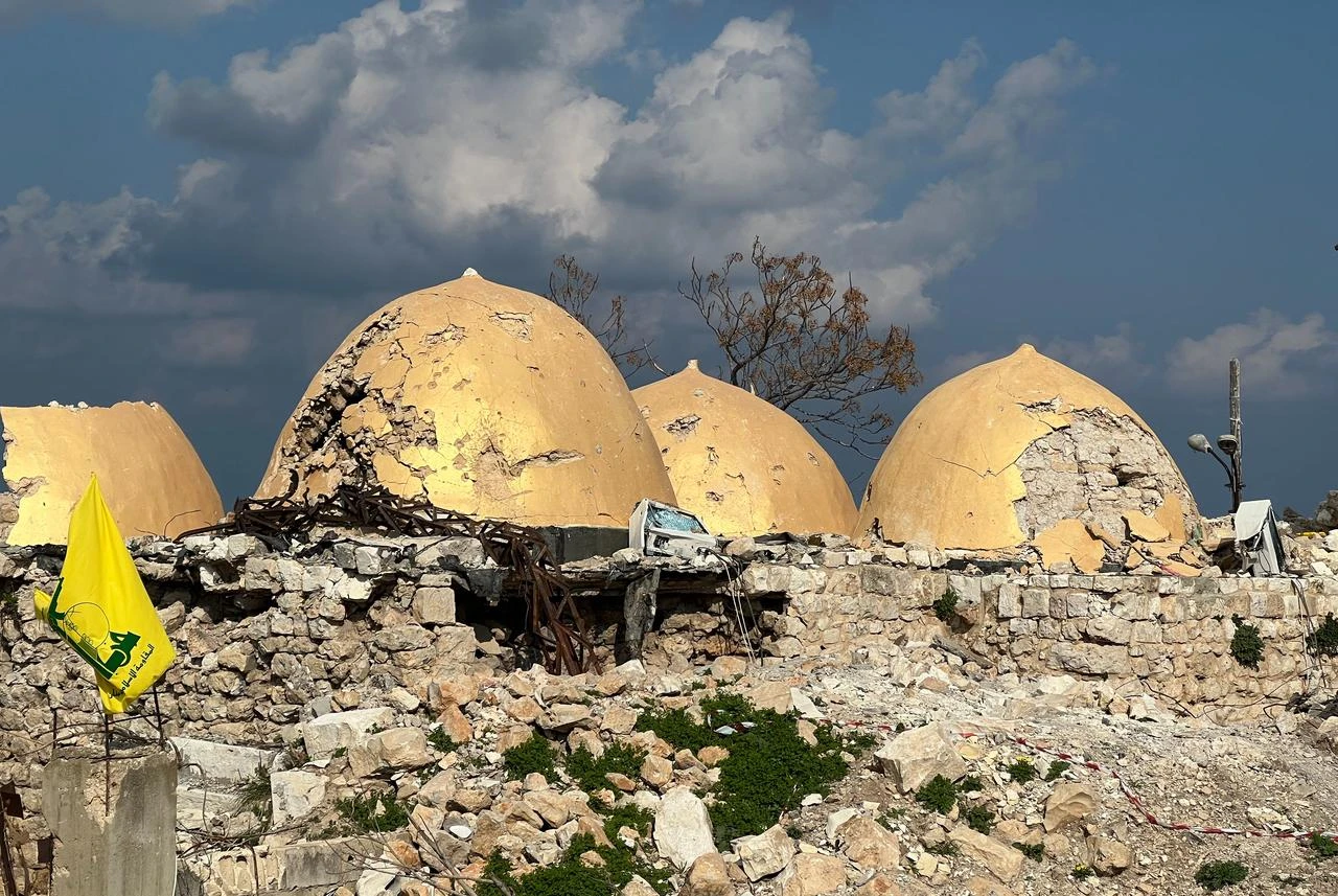 A Hezbollah flag is placed in front of the heavily damaged shrine of Shamoun al-Safa, built within a historical castle in the village of Shamaa in southern Lebanon's Tyre governorate, on January 31, 2025. (AFP File Photo)