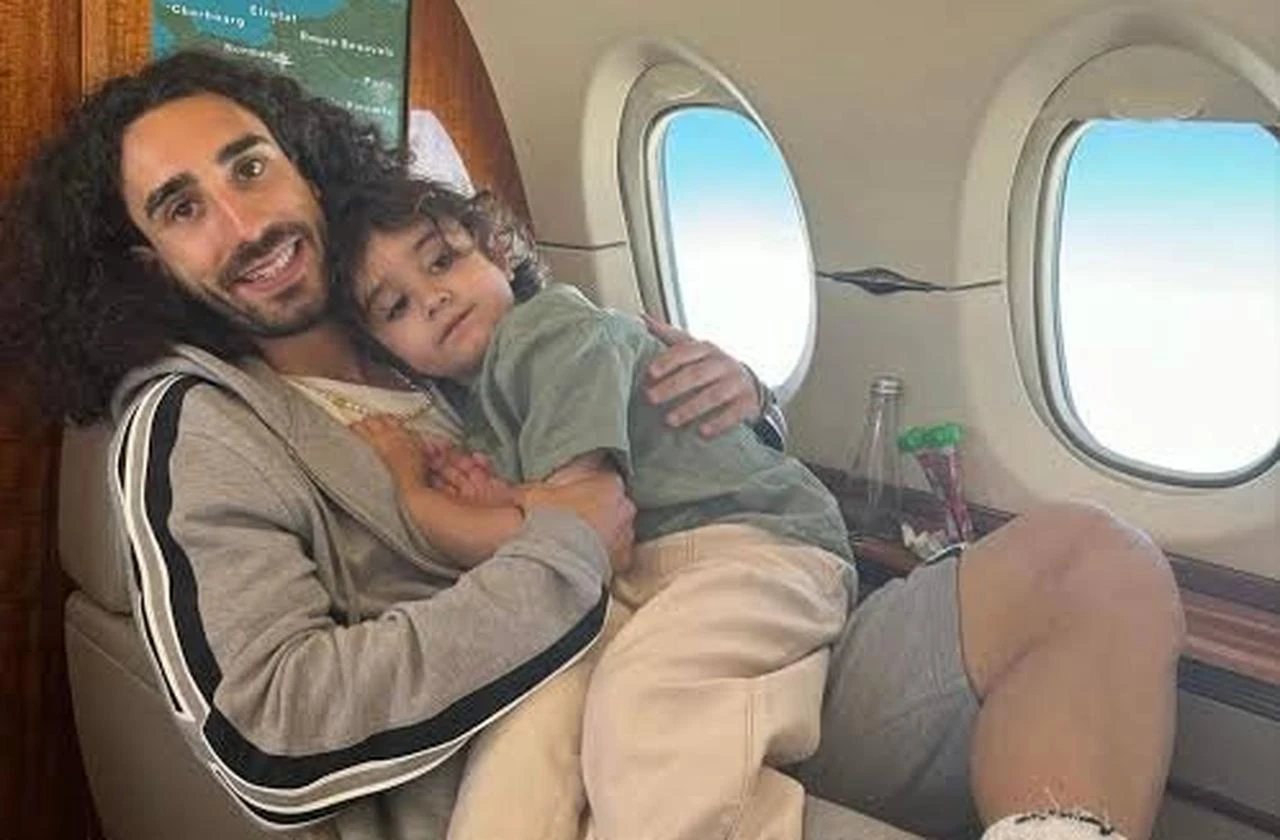 Marc Cucurella holds his son Mateo aboard an aircraft in an photo. (Photo via X/@Fabrizo_km)