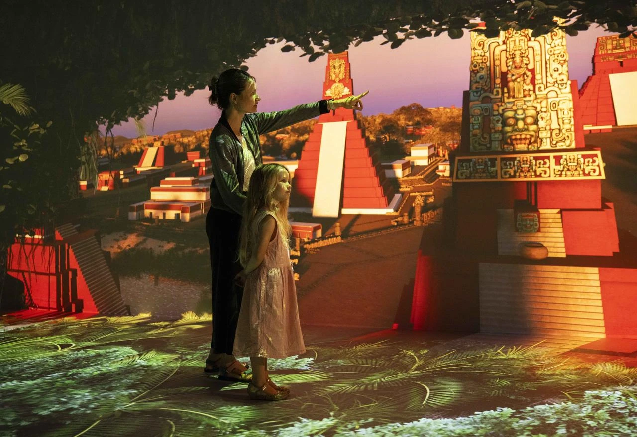 A family explores an immersive reconstruction of the Maya civilization at the Timewalk Exhibition in London, United Kingdom. (AA Photo)