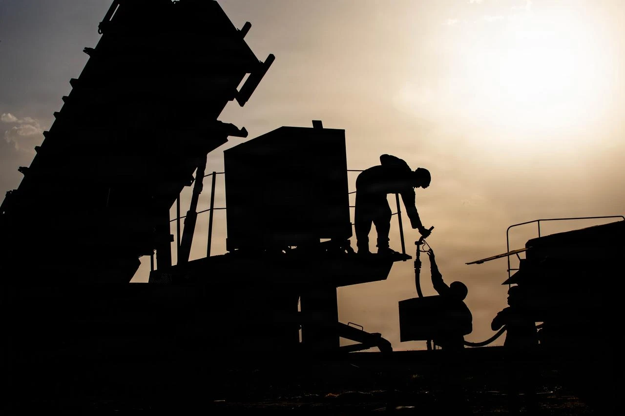 U.S. Army specialists prepare to fuel a generator for a Patriot missile system in the Middle East. (Photo via U.S. Army)