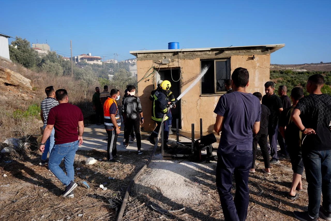 Firefighting teams extinguish the fire as dozens of Israelis, under the protection of the Israeli army, raid the town of Sarra, affiliated with the city of Nablus, West Bank, Palestine on July 24, 2026. (AA Photo)