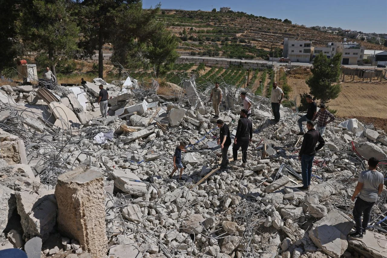 Local residents look for their belongings amid the rubble of Palestinian house that was demolished by Israeli security forces' as it was reportedly built without a permit in the village of Sa'ir, east of Hebron in the occupied West Bank, July 21, 2026. (AFP Photo)