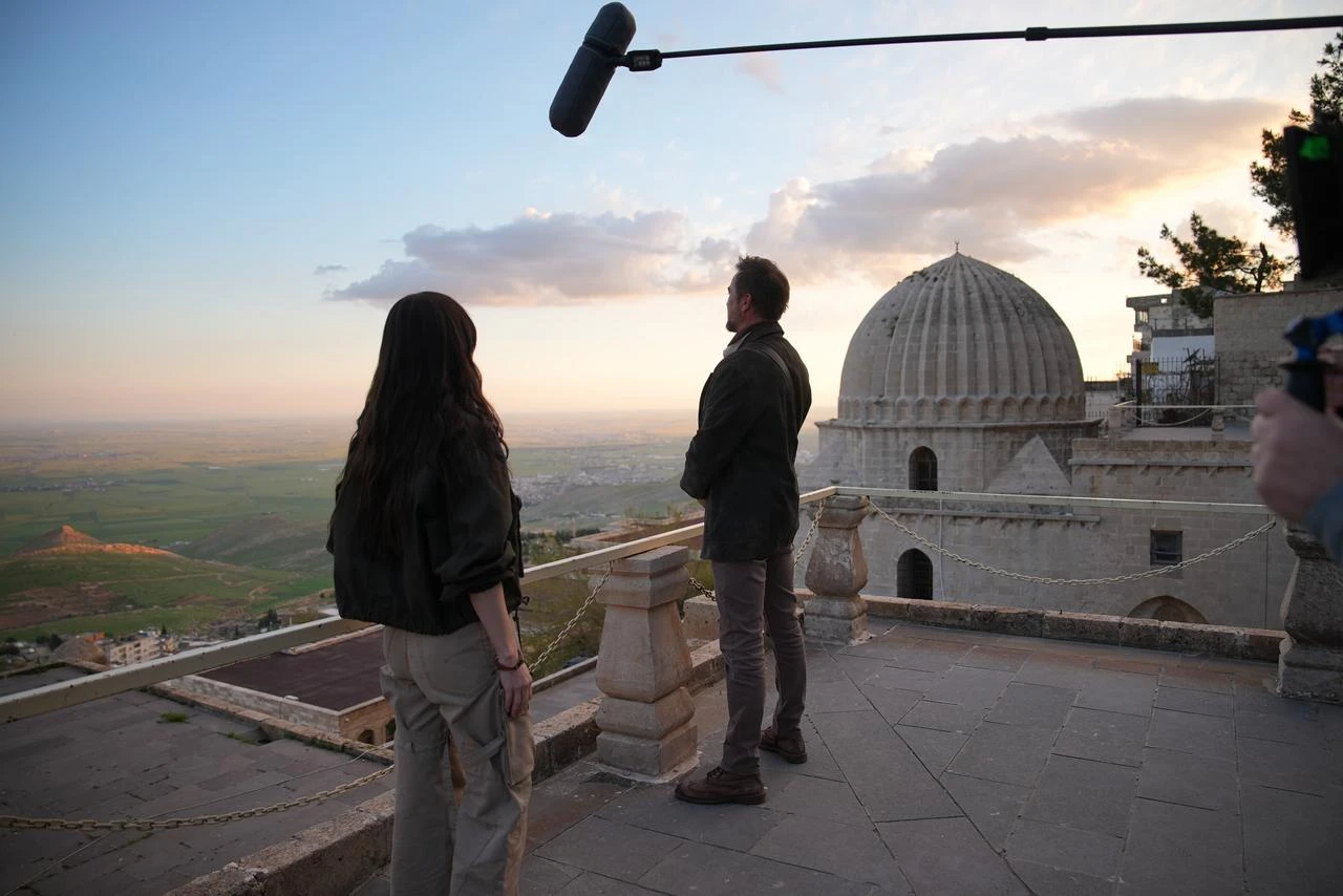 A behind-the-scenes view shows Engin Altan Duzyatan and Ozge Gurel filming a scene overlooking the historic skyline of Mardin for GO Türkiye's Whispers of Origins mini-series. (AA Photo)