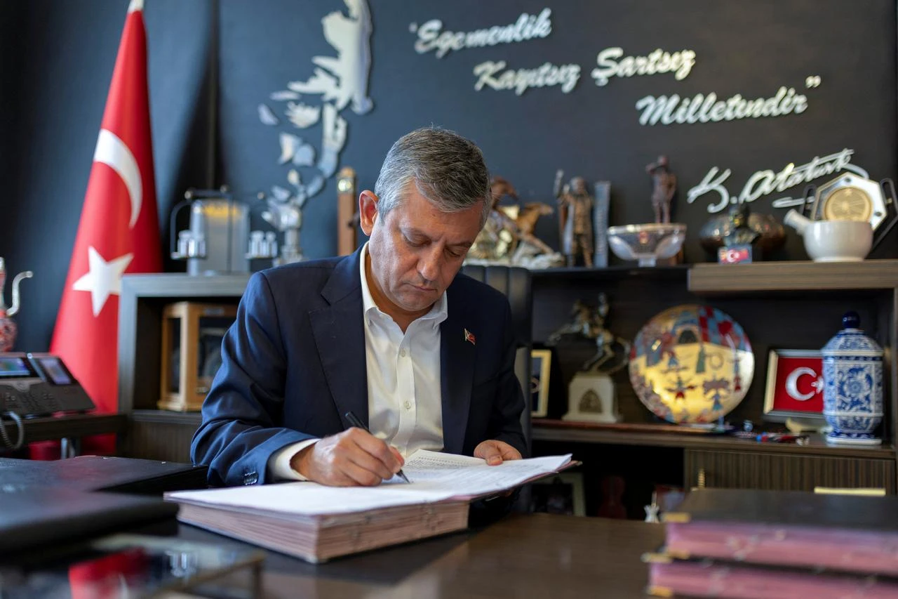 This handout photograph taken and released by Ozgur Ozel's press office on July 24, 2026, shows Ozgur Ozel, signing the founding documents of the YENI Party as he resigned from the Republican People’s Party (CHP) in Ankara. (Ozgur Ozel Press Office/AFP Photo)