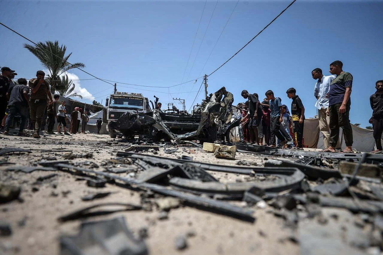Palestinians inspect the charred remains of a targeted vehicle in the Al-Baraka area of Deir al-Balah, Gaza, Palestine on July 26, 2026. (AA Photo)