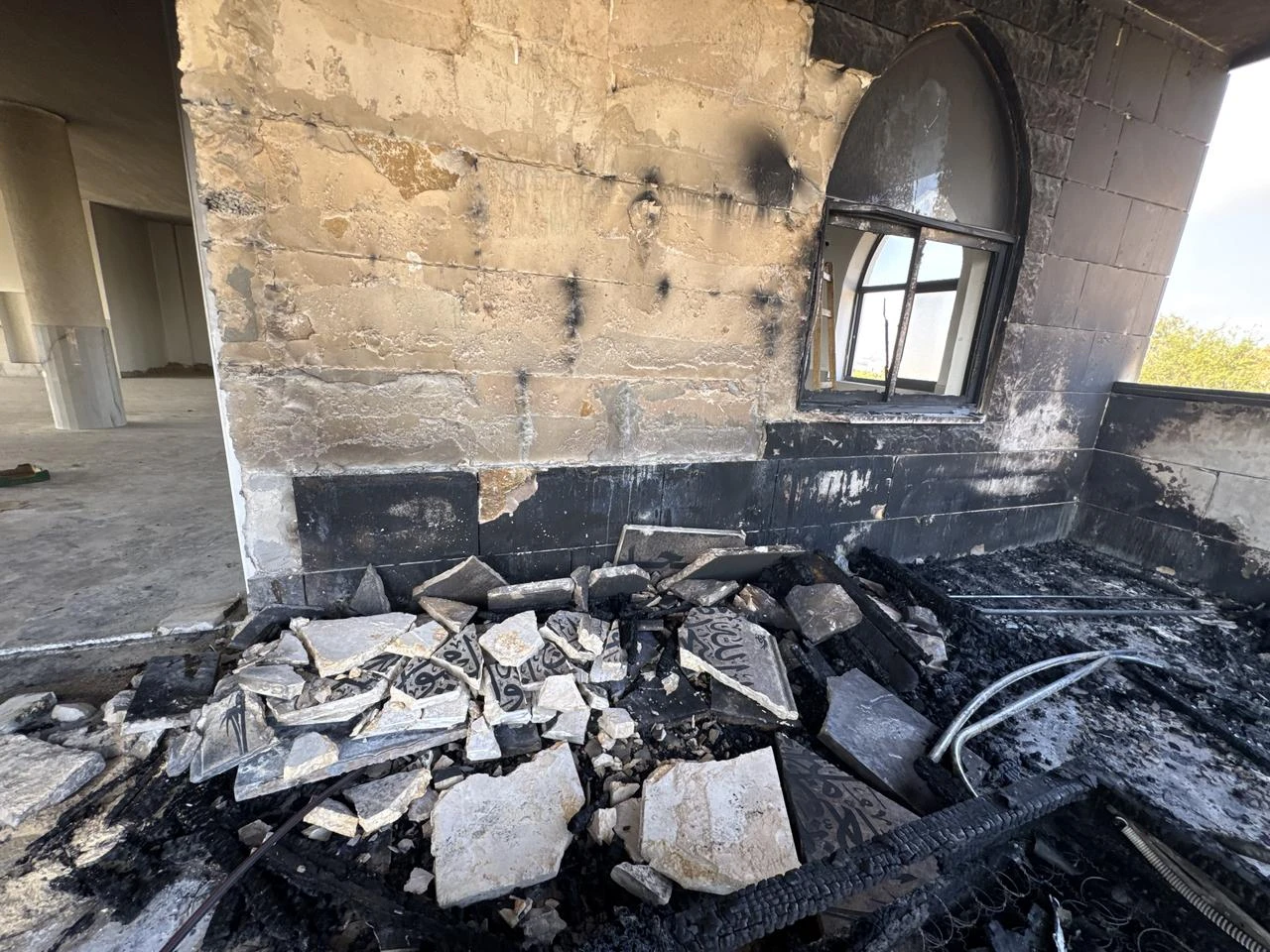 Fire damage is seen at the entrance of Al-Rahmah Mosque following an arson attack by Israeli settlers in the village of Kusra, south of Nablus in West Bank, Palestine, July 26, 2026. (AA Photo)
