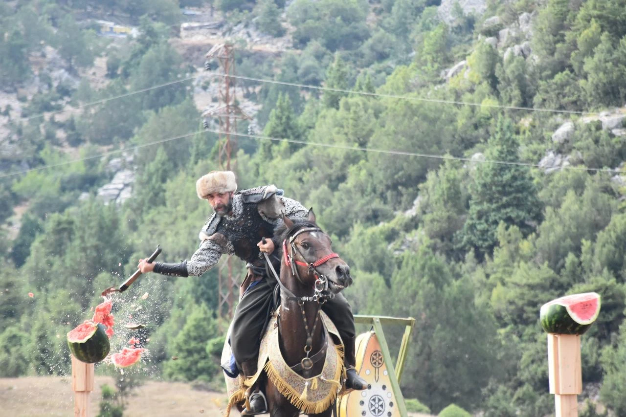 A mounted performer splits a watermelon with an axe during traditional equestrian sports demonstrations in Antalya, Türkiye, July 25, 2026. (AA Photo)