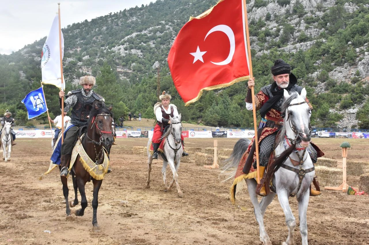 Mounted performers carry the Turkish flag during traditional equestrian sports demonstrations in Antalya, Türkiye, July 25, 2026. (AA Photo)