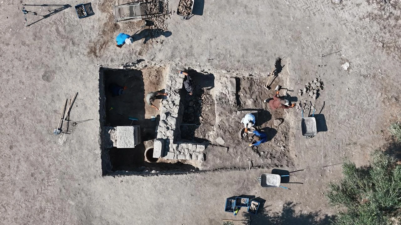 An aerial view shows the excavation team working in the Western Bath area of the Apollo Smintheus Sanctuary in Canakkale, northwestern Türkiye, July 2026. (IHA Photo)