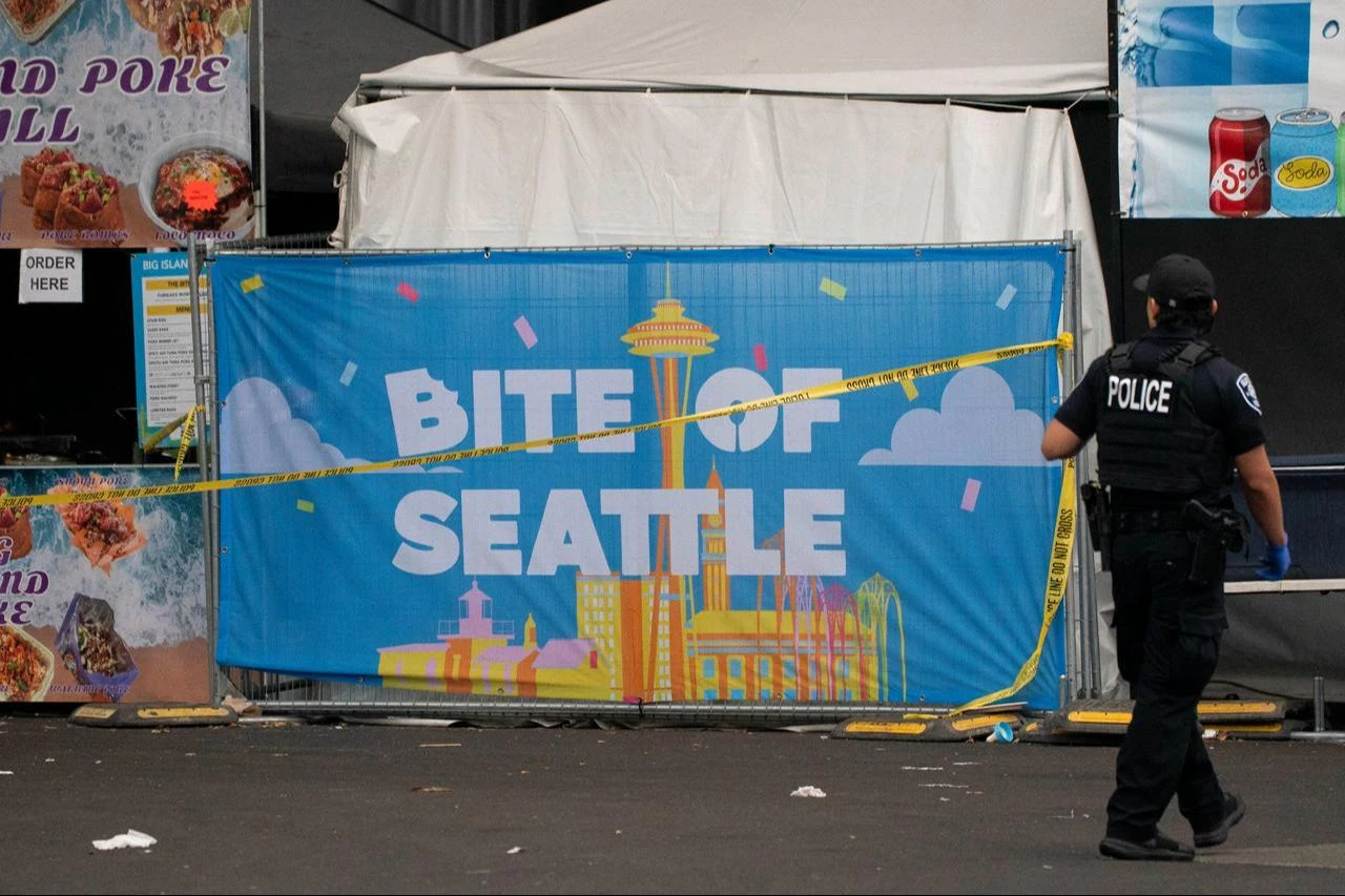 A police officer walks by a sign for the Bite of Seattle food festival on July 26, 2026, in Seattle, Washington. (AFP Photo)