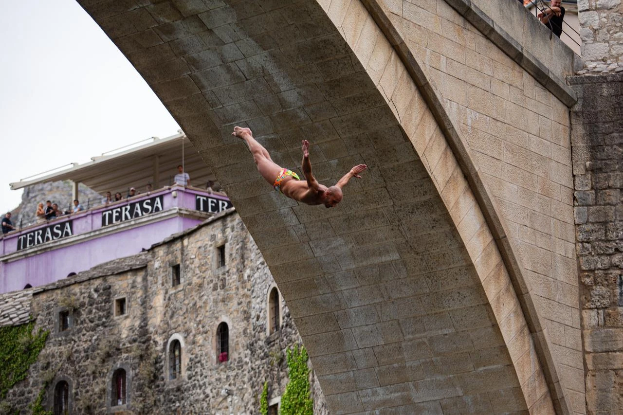 Divers dive from the 16th-century Old Bridge as thousands of residents and tourists gathered to watch the 460th Traditional Diving Competition, one of the country's most recognizable sporting and cultural events in Mostar, Bosnia and Herzegovina on July 26, 2026. (AA Photo)