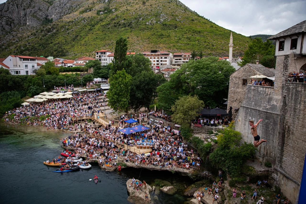Divers dive from the 16th-century Old Bridge as thousands of residents and tourists gathered to watch the 460th Traditional Diving Competition, one of the country's most recognizable sporting and cultural events in Mostar, Bosnia and Herzegovina on July 26, 2026. (AA Photo)