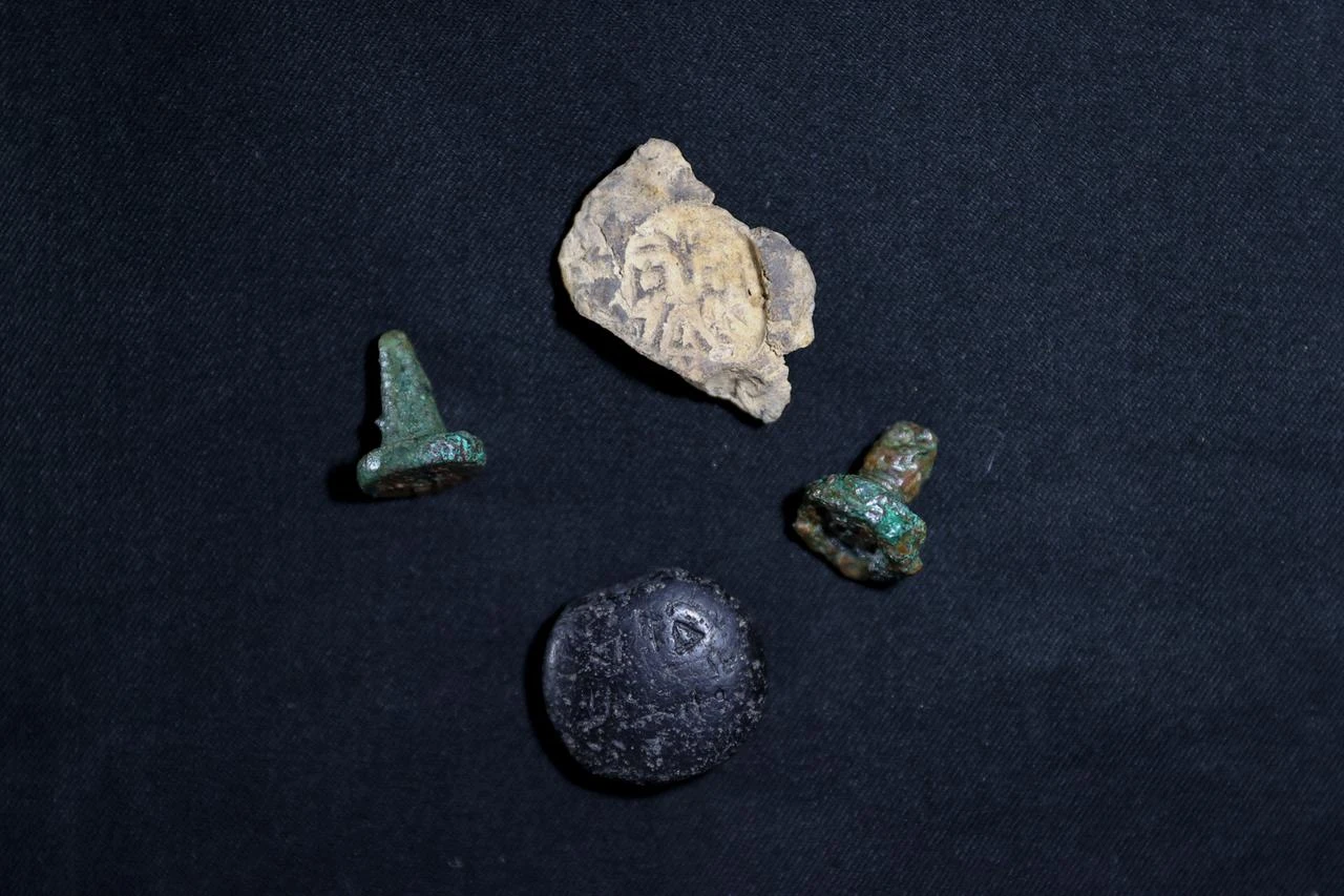 A stone seal, two copper seals and a clay seal impression uncovered at Turkmen Karahoyuk are displayed together. (AA Photo)