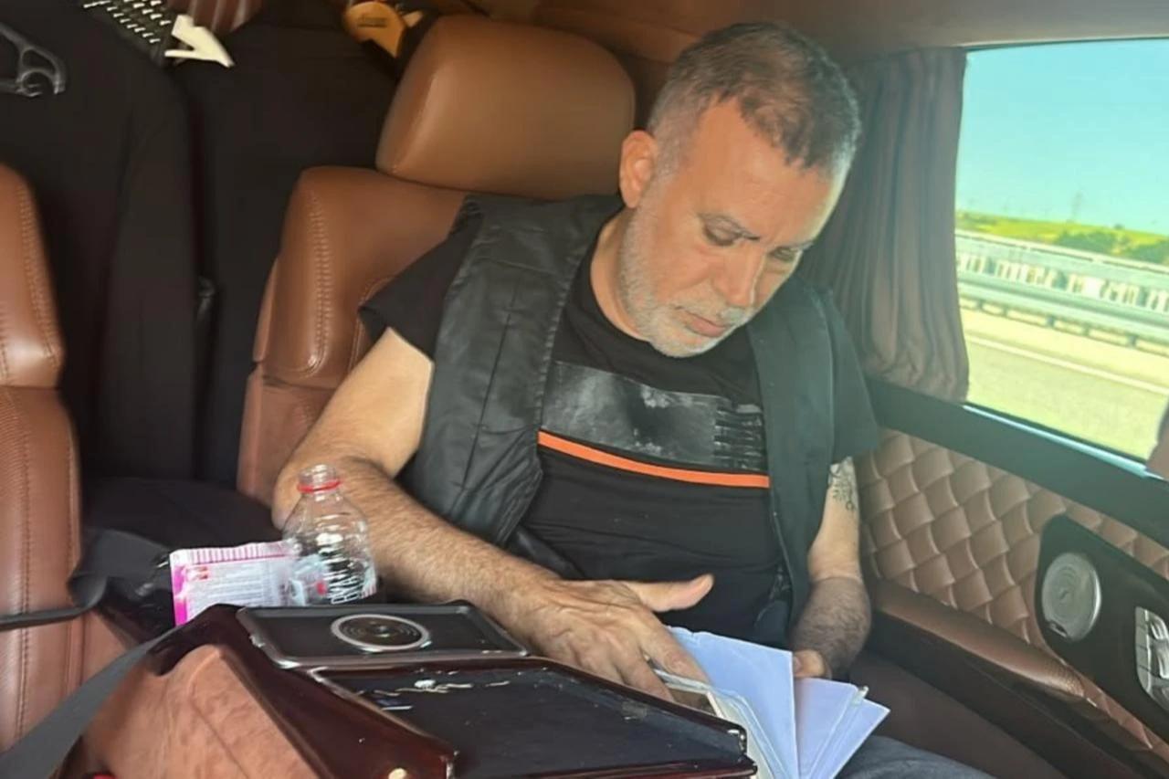 Turkish singer Haluk Levent reviews documents while traveling in a vehicle in Türkiye in this undated archive photograph. (IHA Photo)