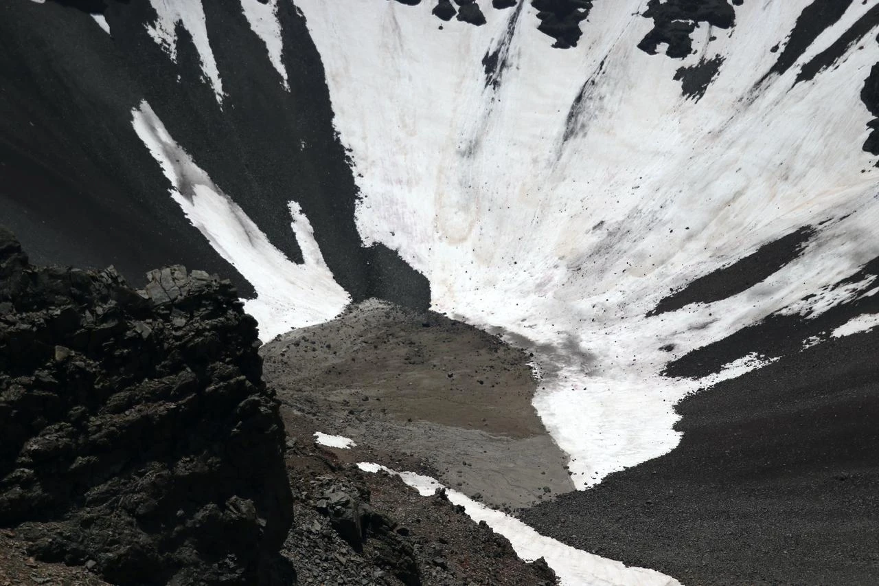 Snow remains along the dark volcanic slopes of Tendürek Crater in eastern Türkiye, July 27, 2026. (AA Photo)