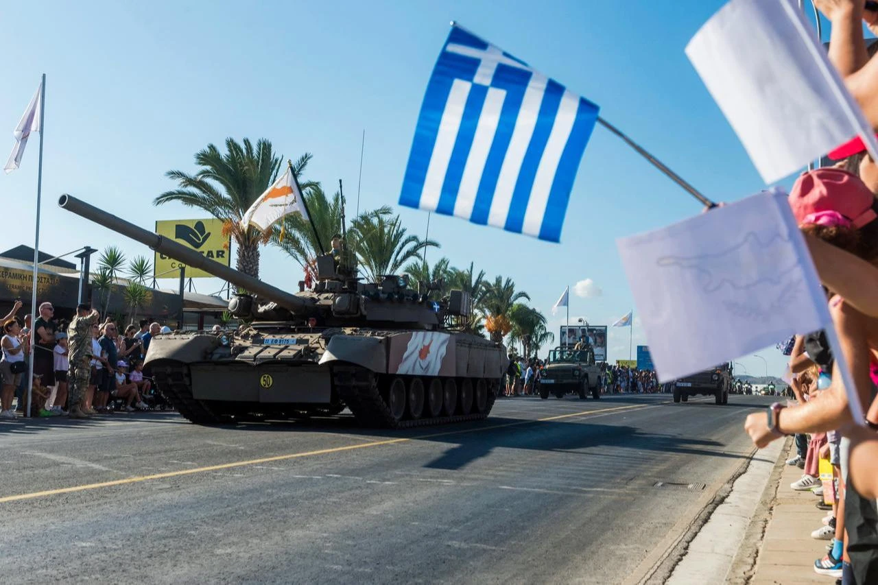People watch as soldiers in a tank take part in a military parade in Nicosia on October 1, 2025. (AFP Photo)
