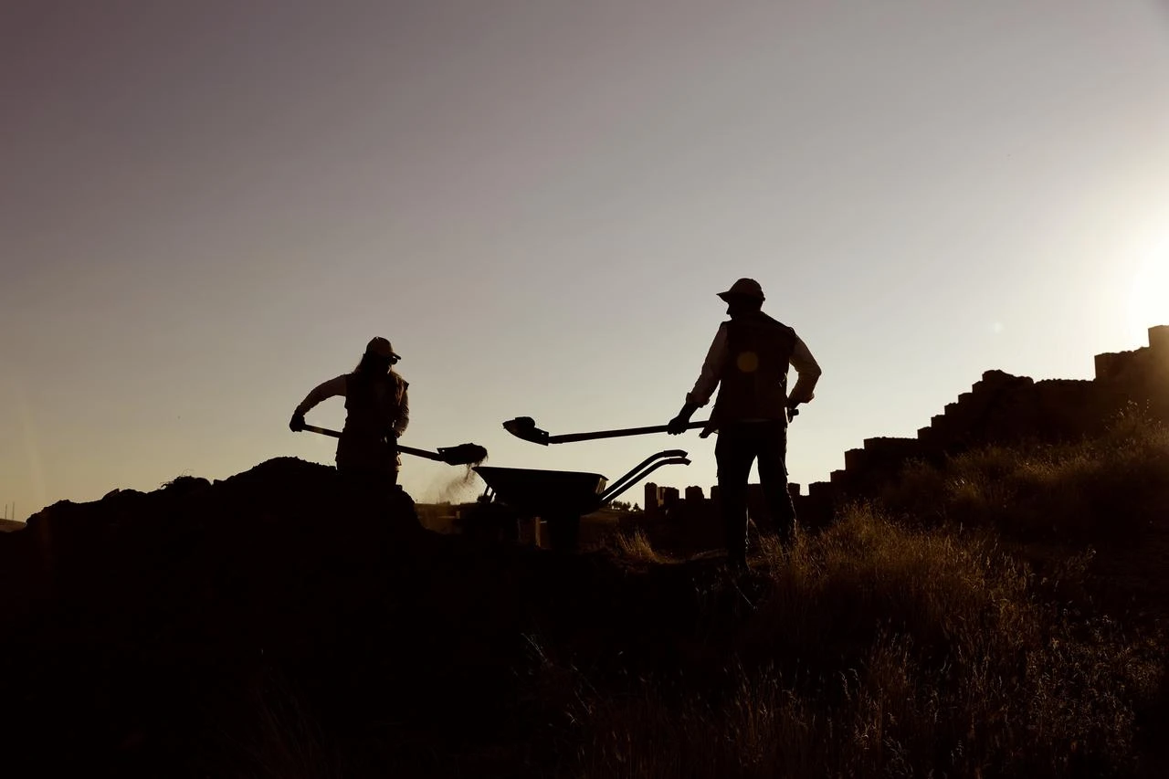 Archaeologists work at sunset during excavations at Bayburt Castle, where findings have revealed occupation layers extending back to the Early Bronze Age, July 28, 2026. (AA Photo)