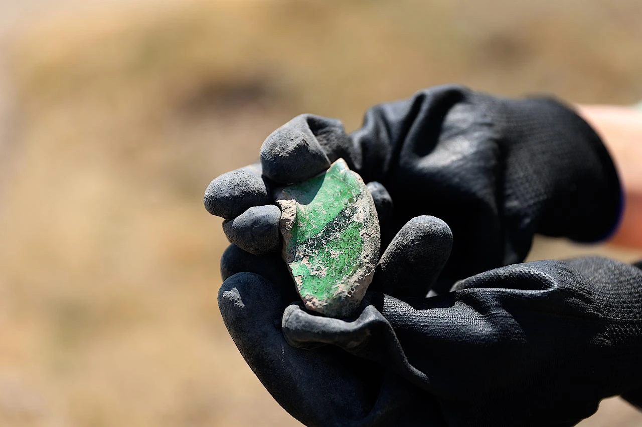 An archaeologist displays a fragment of a vessel uncovered during excavations at Bayburt Castle in northeastern Türkiye, July 28, 2026. (AA Photo)