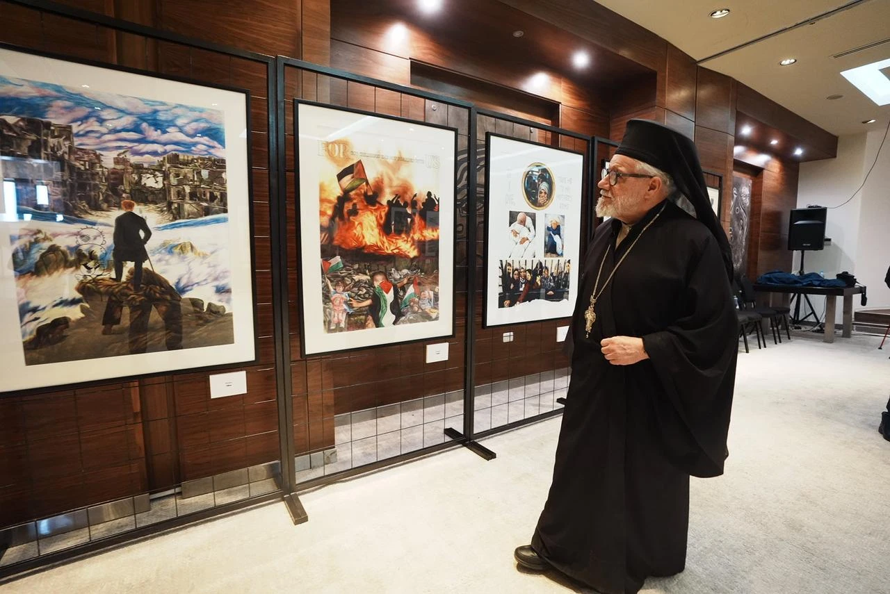 Visitors view works from Turkish artist Ahmet Yusuf Aygec's exhibition "Posters to the Olive Tree in Exile" at the Mahmoud Darwish Museum in Ramallah, occupied West Bank. (AA Photo)