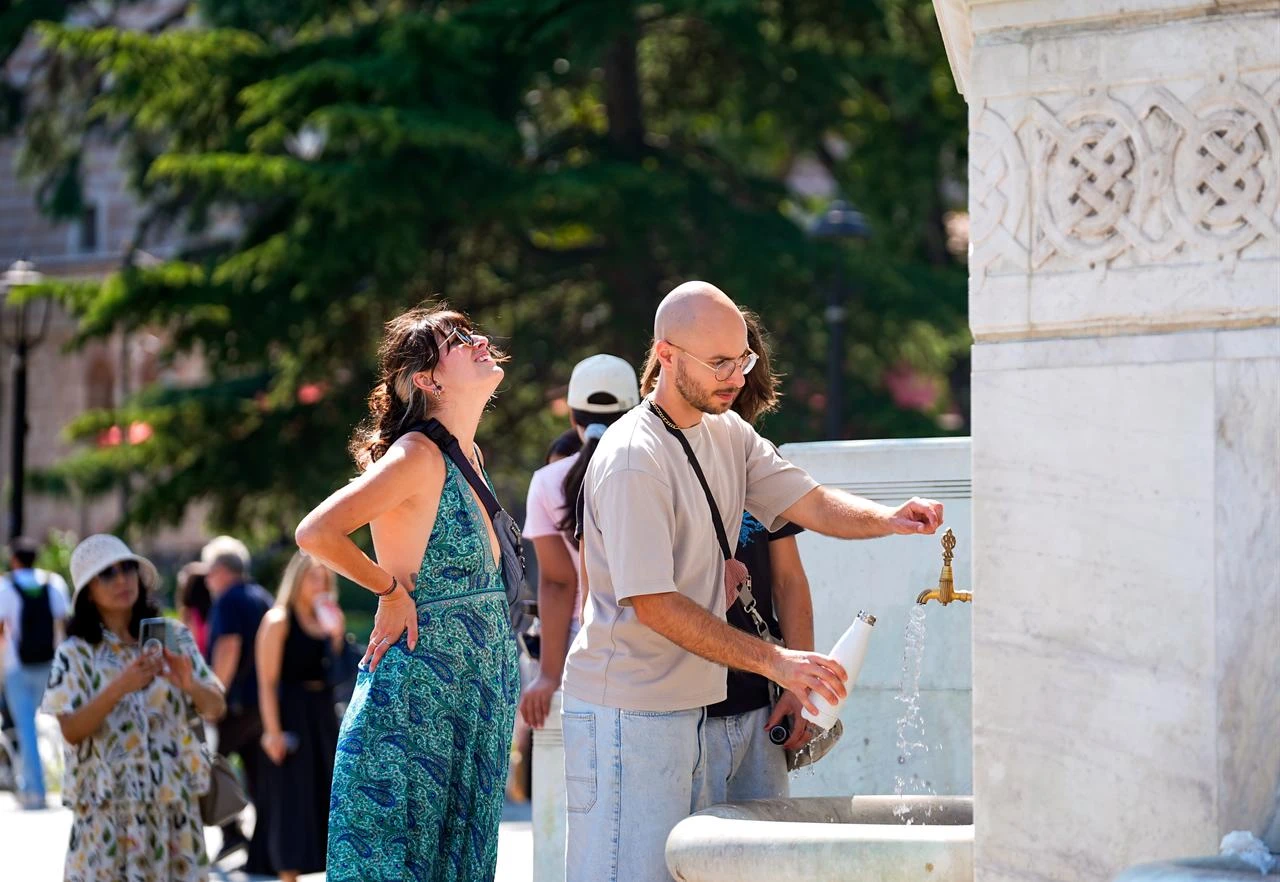 Visitors cool off at a public fountain during hot weather in Istanbul, Türkiye, July 22, 2026. (AA Photo)