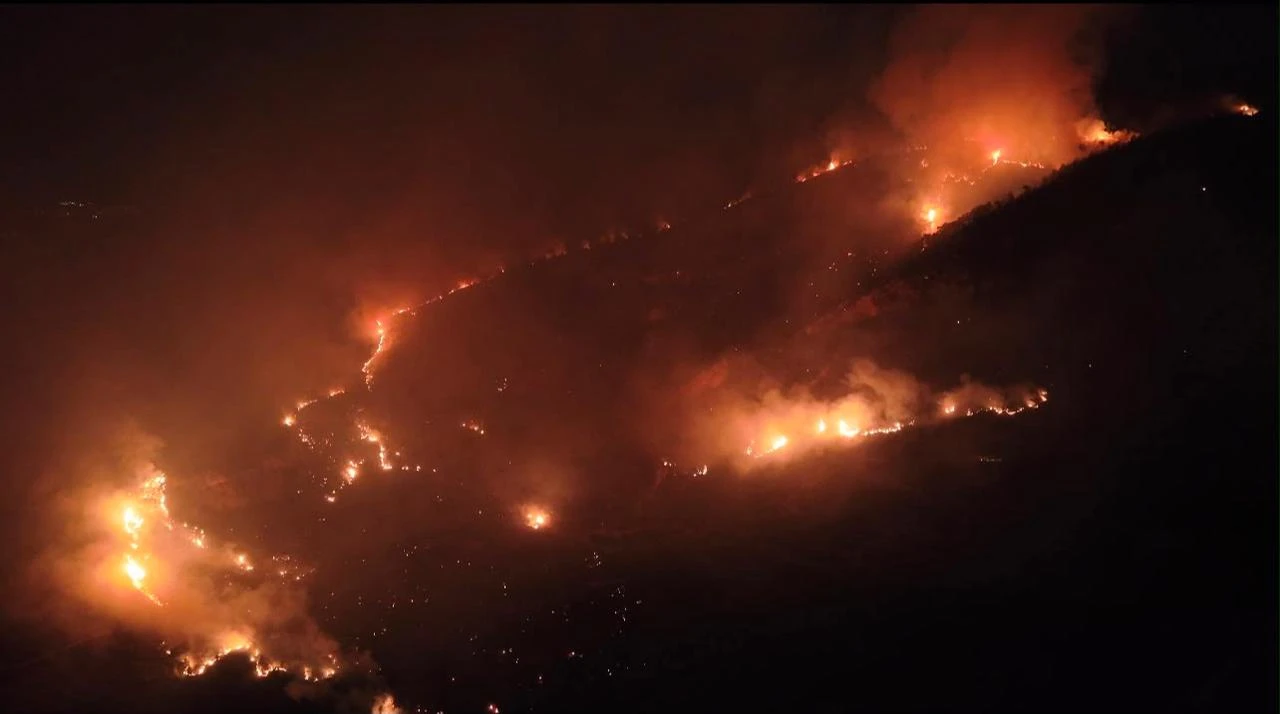 Flames and smoke rise from a forest fire as crews continue ground operations into the evening in the Kas district of Antalya, Türkiye, on July 28, 2026. (AA Photo)