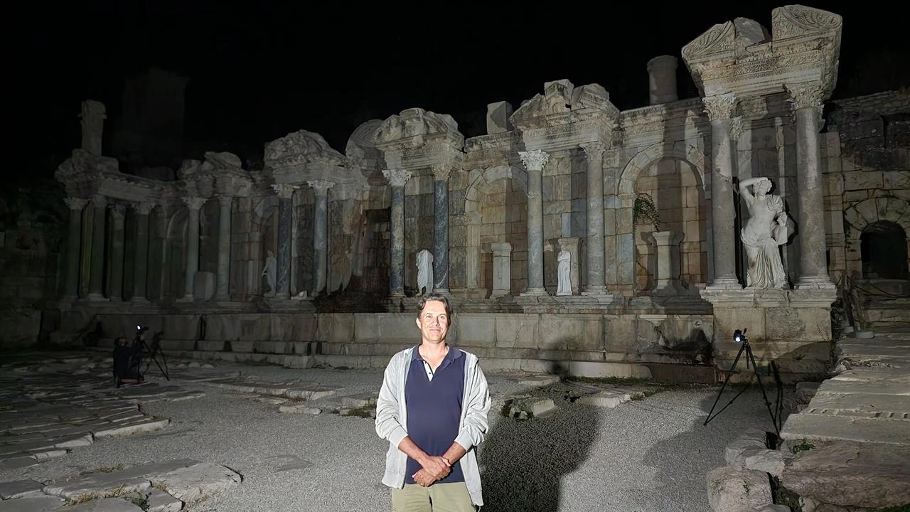 Professor Peter Talloen poses in front of the restored Antonine Fountain at the ancient city of Sagalassos in Burdur, Türkiye, in this file photo. (IHA Photo)