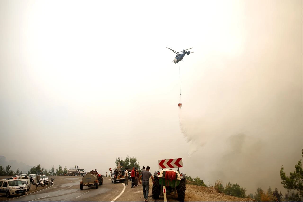 Firefighting efforts continue by air and land to contain a forest fire that broke out in Seydikemer district of Mugla, Türkiye, on July 29, 2026. (AA Photo)