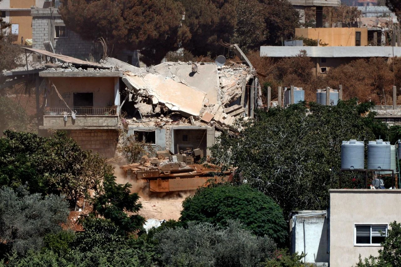 A photograph taken from the southern Lebanese village of Zawtar al-Gharbiyah shows Israeli armoured vehicles manoeuvering in the nearby village of Zawtar al-Charkiyah, July 28, 2026. (AFP Photo)