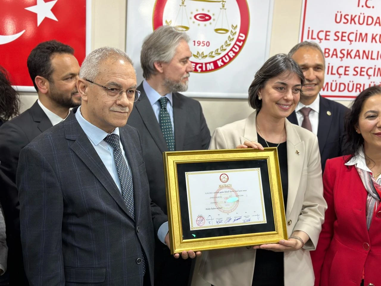 Newly elected Uskudar Mayor Sinem Dedetas holds her certificate of election during the official handover ceremony at the Uskudar District Election Board in Istanbul, Türkiye, April 4, 2024. (IHA Photo)