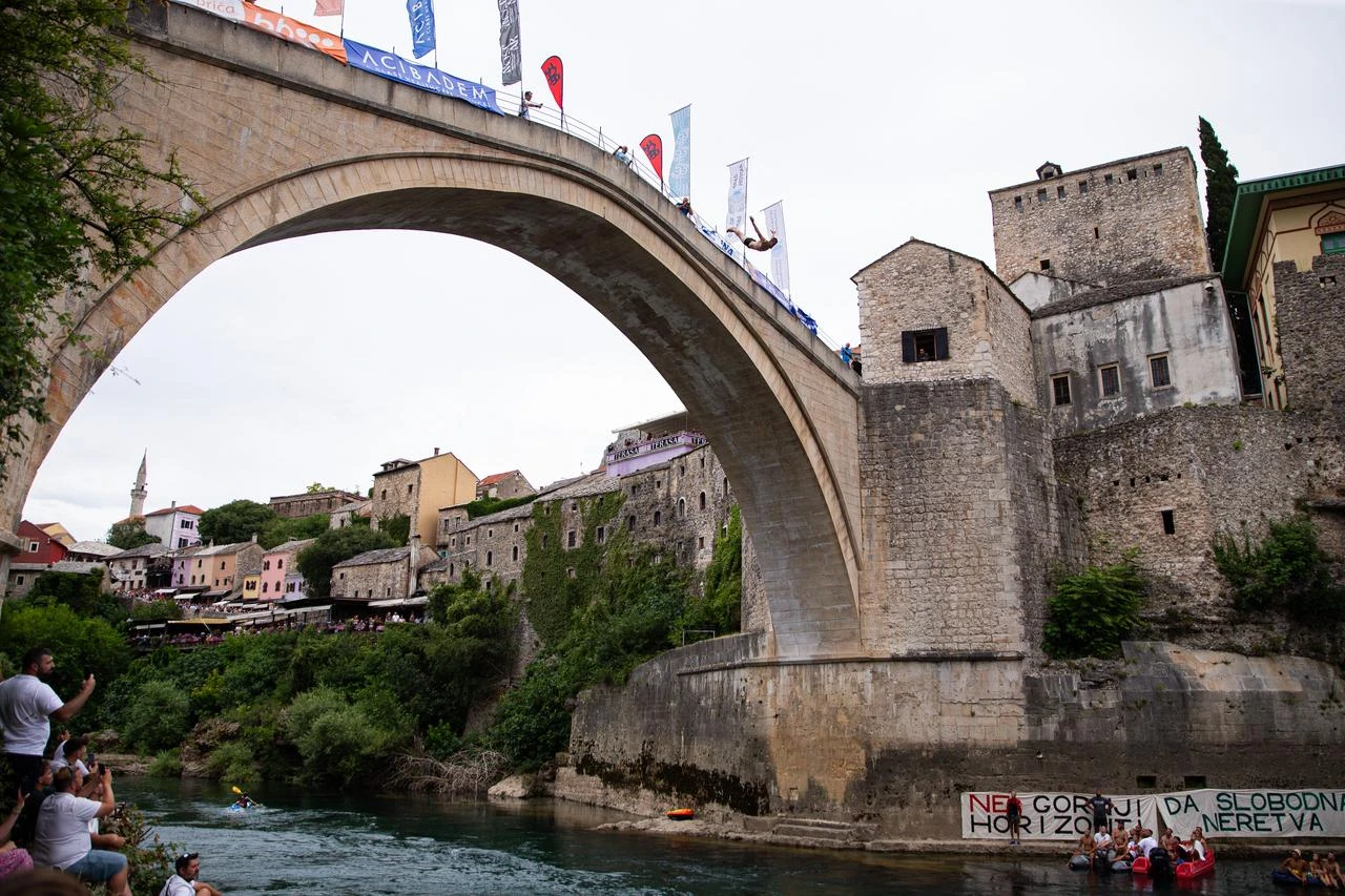 Divers dive from the 16th-century Old Bridge as thousands of residents and tourists gathered to watch the 460th Traditional Diving Competition, one of the country's most recognizable sporting and cultural events in Mostar, Bosnia and Herzegovina on July 26, 2026. (AA Photo)